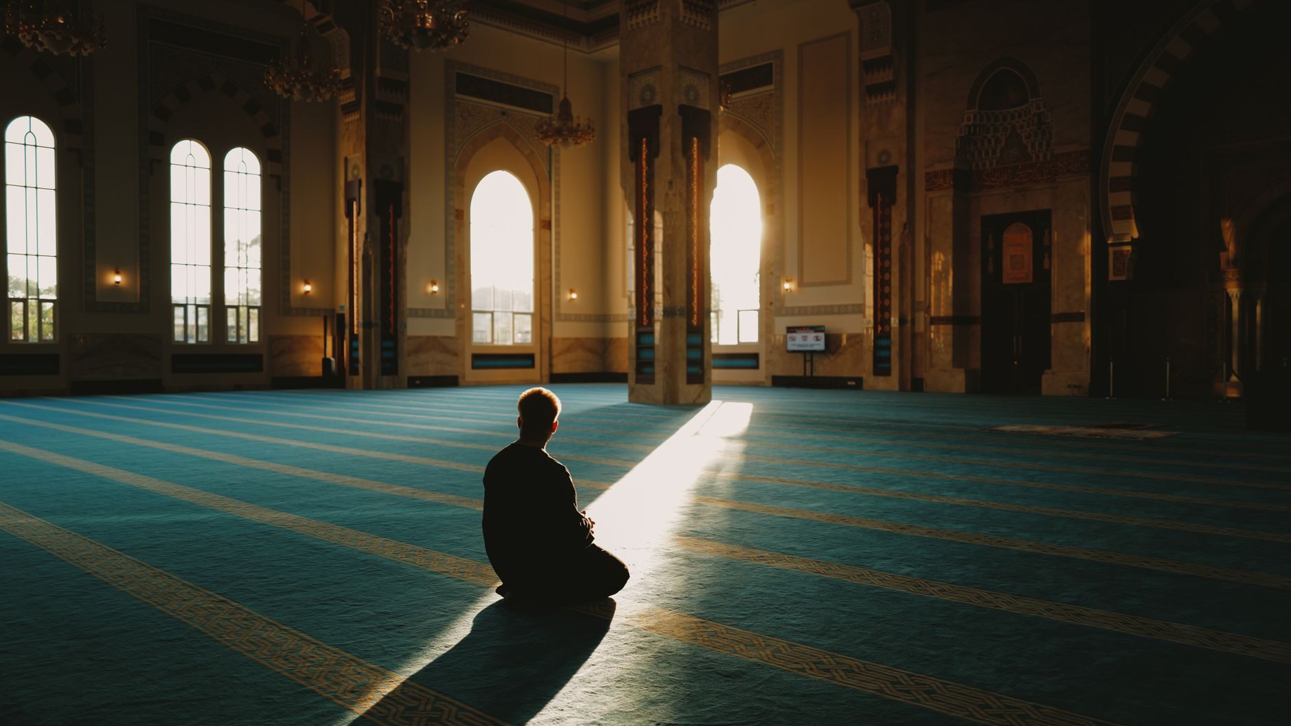 peaceful moment of prayer in serene mosque interior